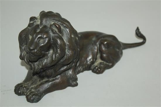 A patinated bronze model of a recumbent lion, 9in.